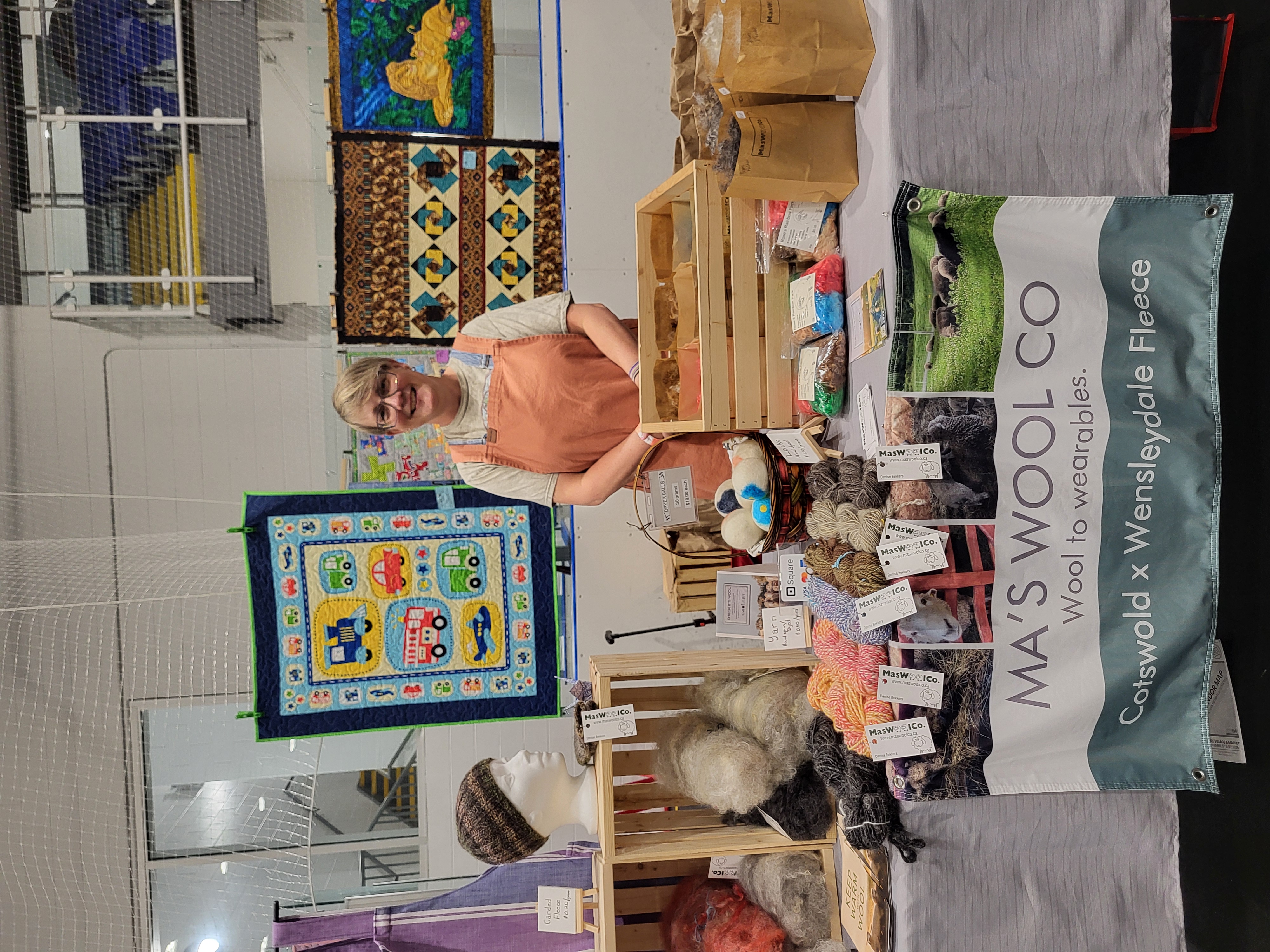 Seller stands at yarn booth