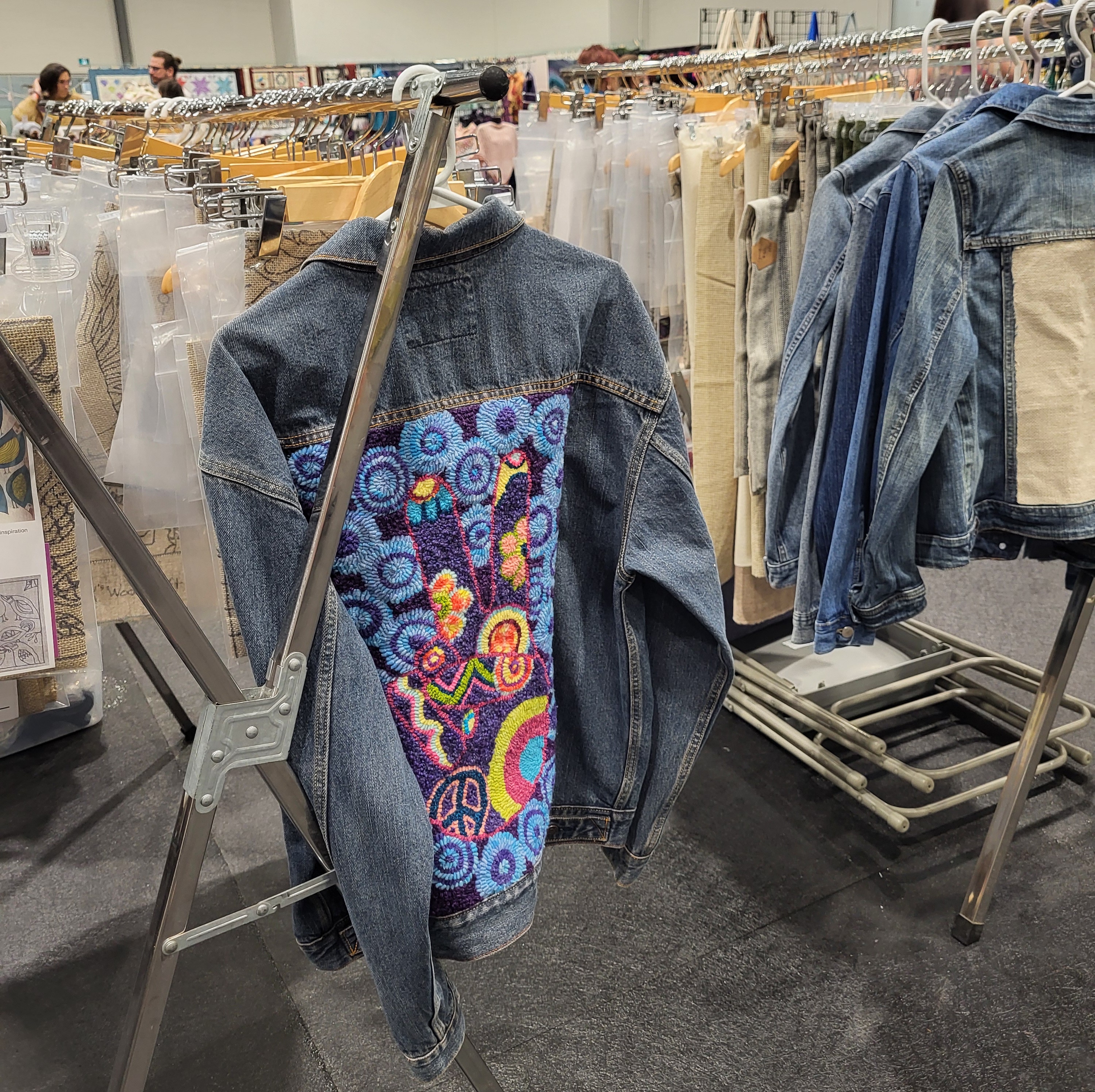 Jean jacket altered with a rug hooking pattern 